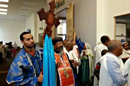 A deacon carries a cross during a celebration at Saint Mary's Ethiopian Orthodox Church in Aurora. Ethiopians make up the largest single nationality in Colorado's African community. Many settled in the state decades ago and say that as they've put down roots and raised children here, they've become increasingly politically involved - See more at: http://www.cpr.org/news/story/why-colorados-africans-are-rising-political-force#.dpuf